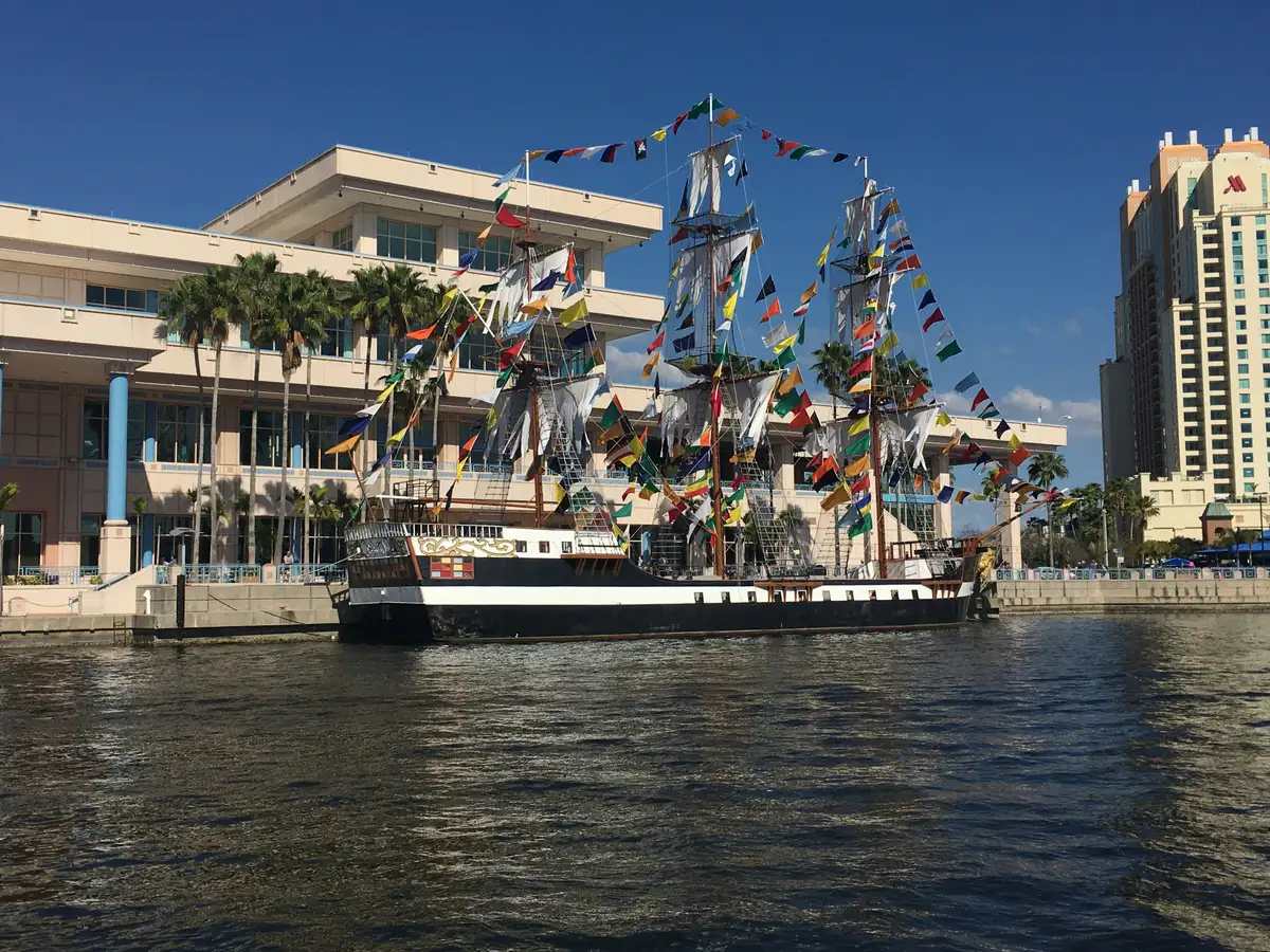 A tall ship docked by the Tampa Convention Center on the Hillsborough River